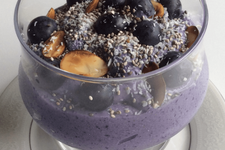 Blueberry and coconut mouse served in a glass cup