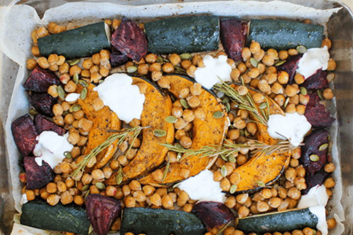 Cinnamon Roasted Chickpeas & Vegetables with Yoghurt Dressing served in a baking dish.