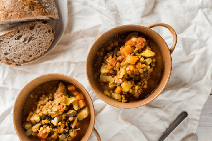 Curried lentil soup in small bowls and bread on the side.