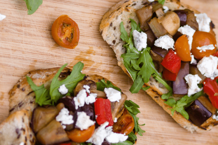 Mediterranean style bruschetta on a wooden table.