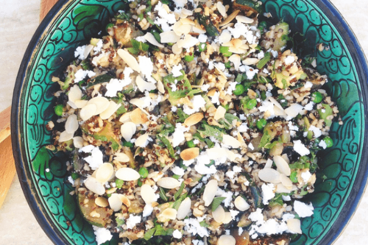 Minty green quinoa brown rice salad served in a blue bowl.