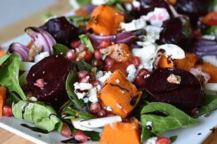 Pumpkin and beetroot salad on a white serving dish.