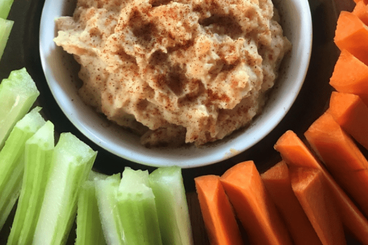 Red lentil hommus served with celery and carrot.