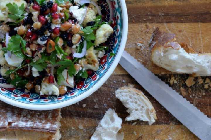 Roasted cauliflower salad with bread on the side.