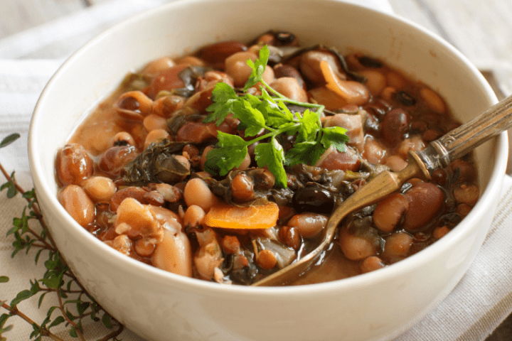 Cooked beans and pasta in a white bowl