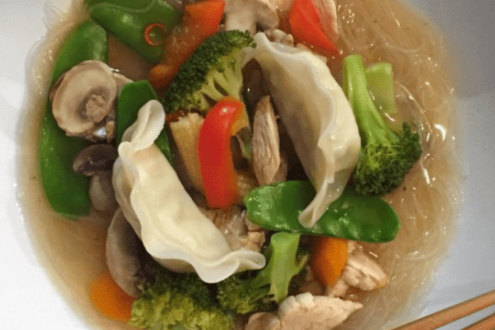 Chicken and vegetables in a white bowl