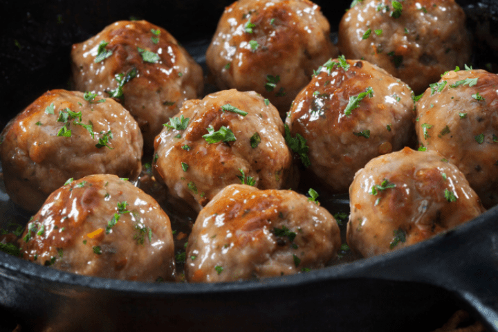 Meatballs cooking in a frying pan