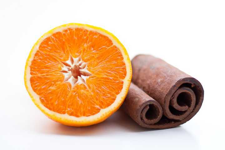 Sliced orange with cinnamon stick