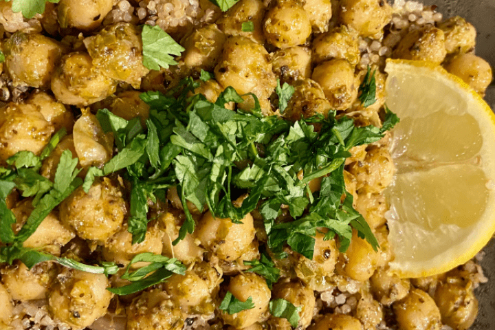 Pesto covered chickpeas with a lemon slice and green garnish