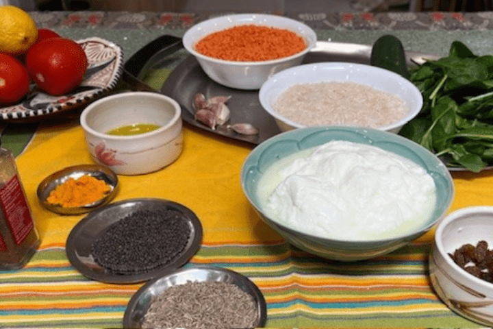 ingredients for a vegetarian dish, including tomatoes, rice, spinach and lentils 