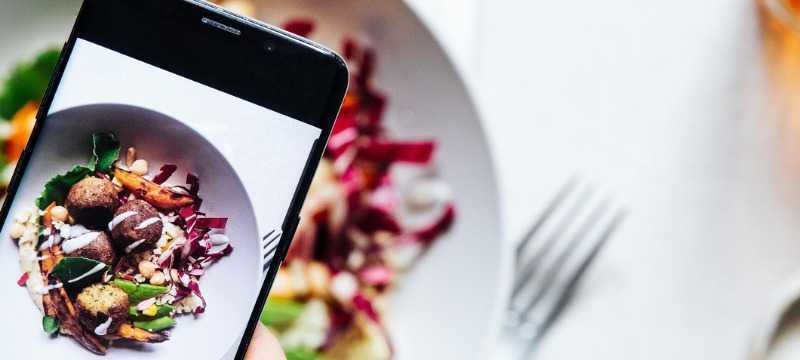 Mobile taking photo of bowl of food