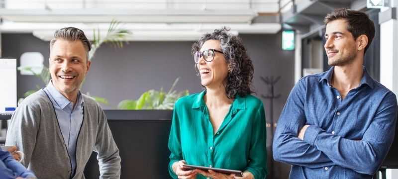 Team of business people talking and smiling