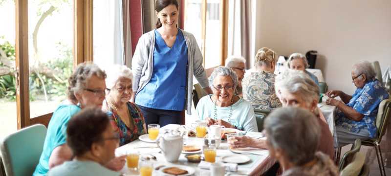 Shot of a group of seniors enjoying breakfast together in their retirement home