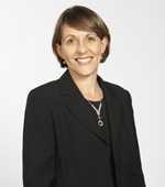 Woman with brown hair and black blazer