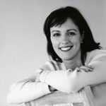 Black and white picture of woman with dark hair smiling at camera