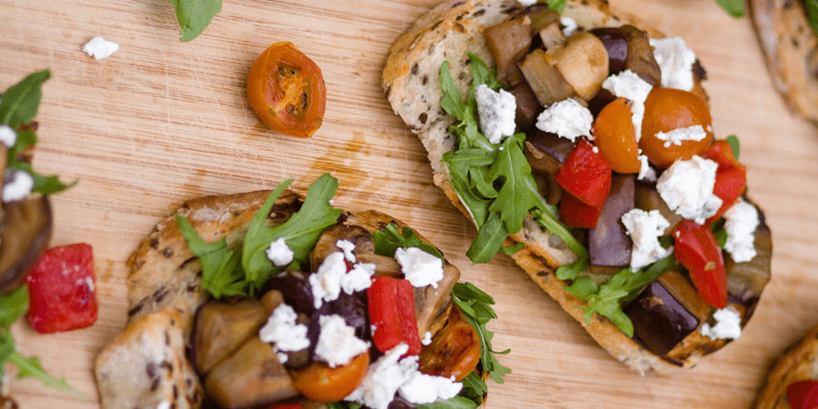 Mediterranean style bruschetta on a wooden table.