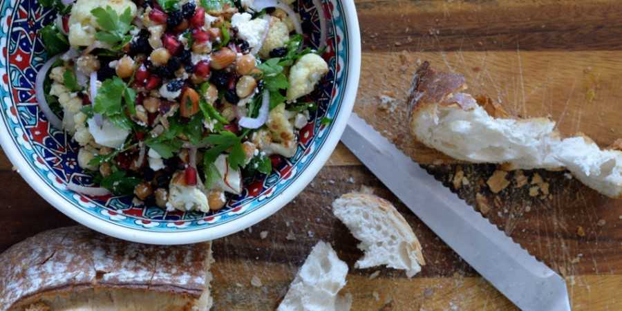 Roasted cauliflower salad with bread on the side.