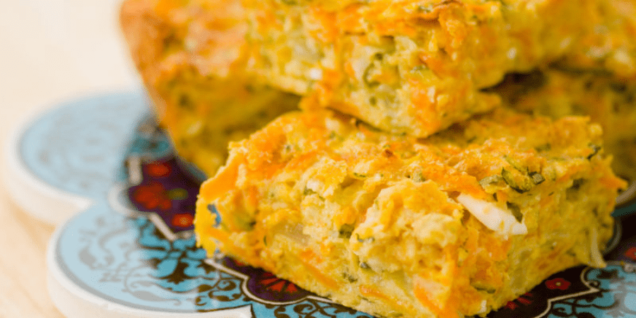A serving of zucchini, carrot and fetta slice.