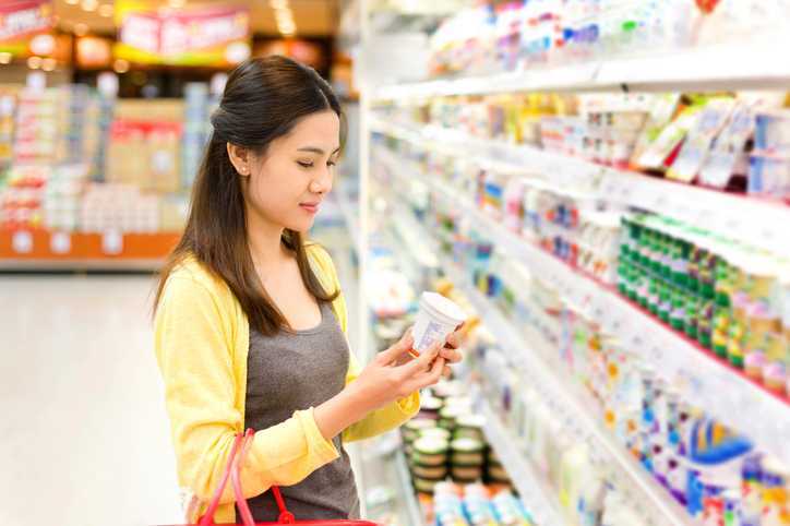 Woman buys dairy products in the supermarket