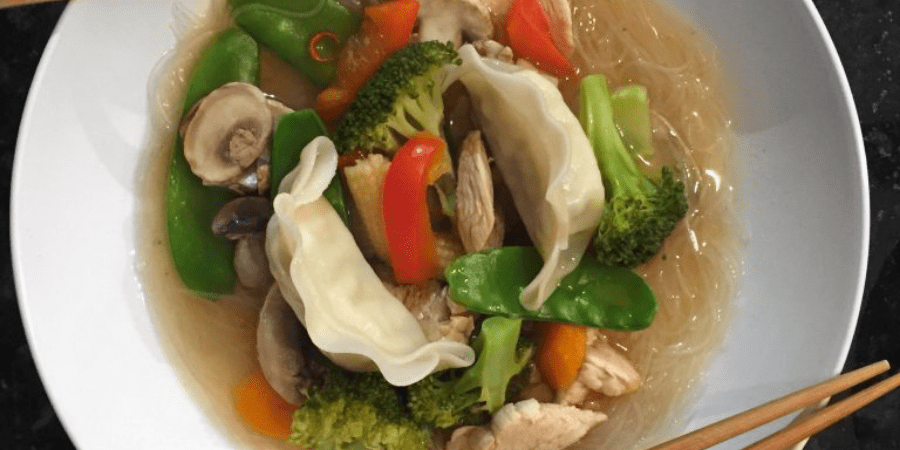 Chicken and vegetables in a white bowl
