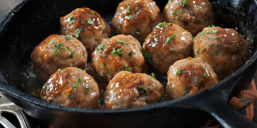 Meatballs cooking in a frying pan