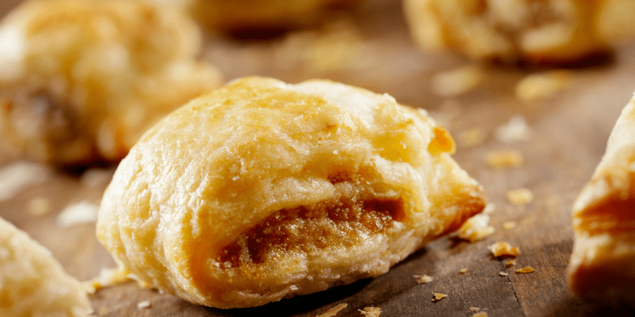 A close up of a cooked sausage roll