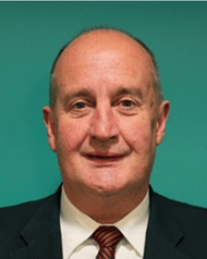 Man wearing a tie smiling at the camera