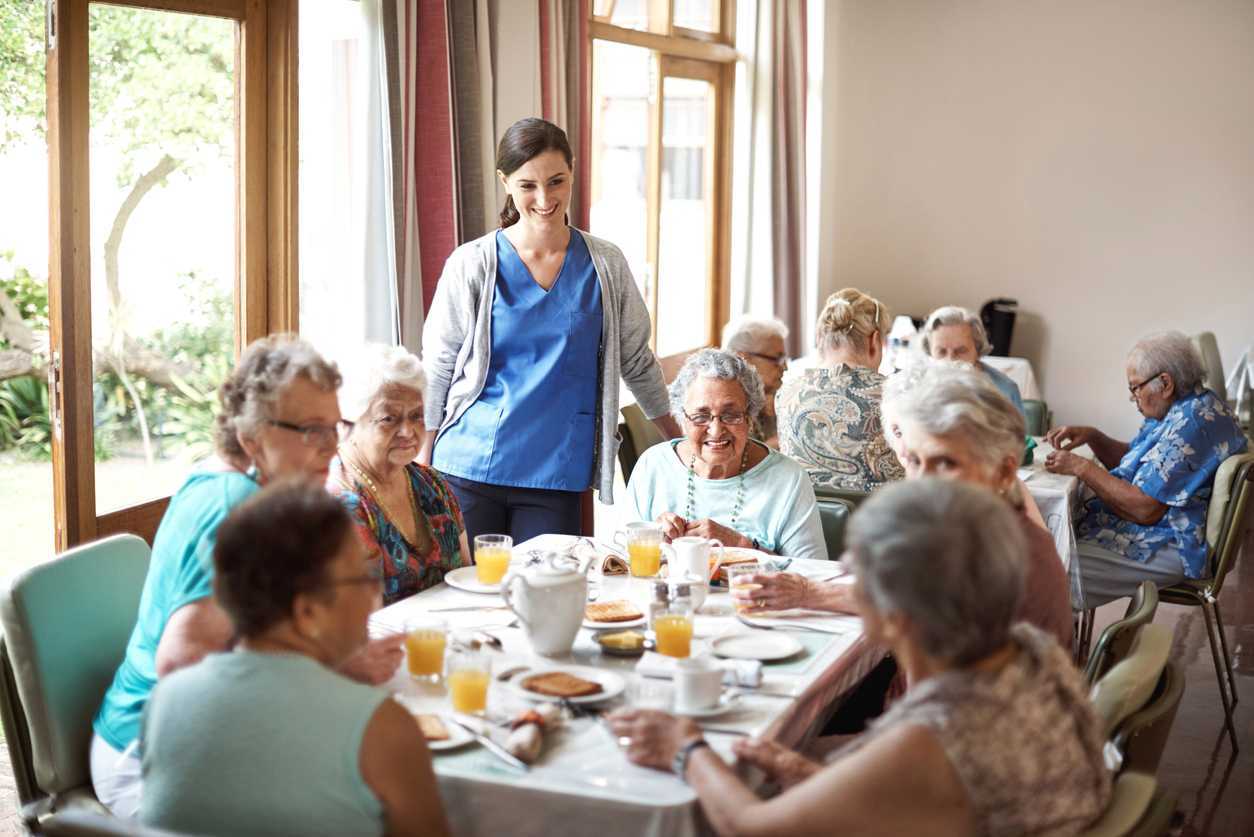 Shot of a group of seniors enjoying breakfast together in their retirement home