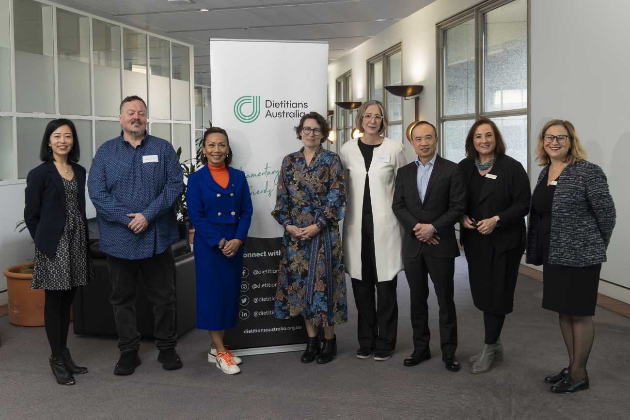 8 people standing in from of a Dietitians Australia sign