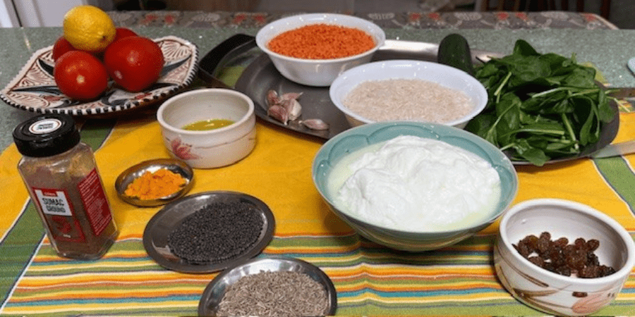 ingredients for a vegetarian dish, including tomatoes, rice, spinach and lentils 