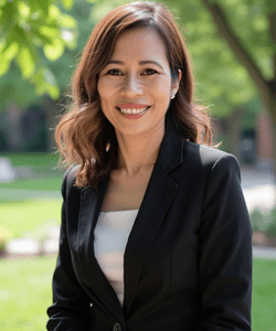 Women smiling wearing a black blazer.